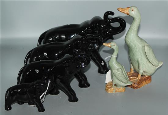 4 graduated black glazed elephants and 2 ducks